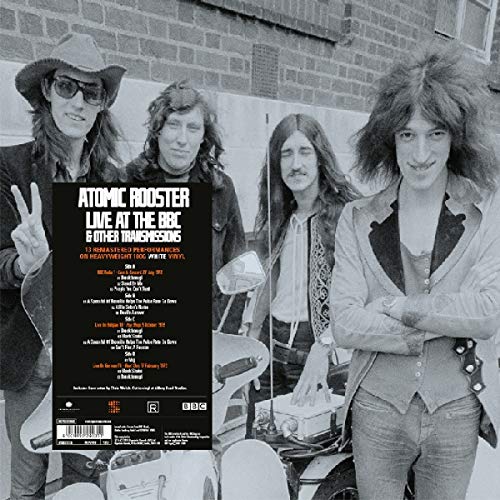 Black and white vinyl album cover featuring four men standing by a car.