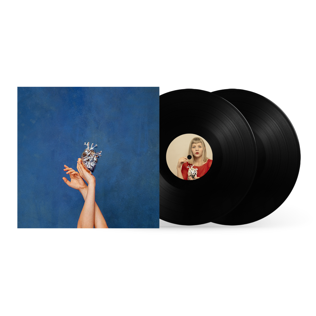 AURORA vinyl record with album art featuring hands holding a metallic heart.