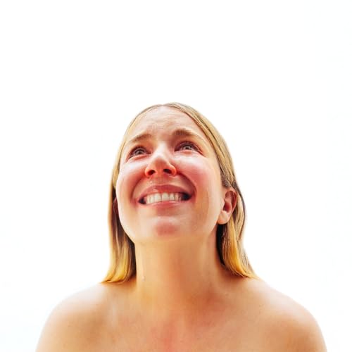 Woman with blonde hair looking upwards, album cover art.