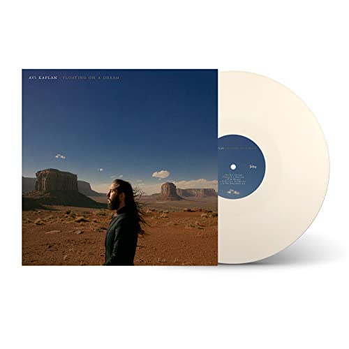 Avi Kaplan album cover showing him in a desert landscape next to a cream vinyl.