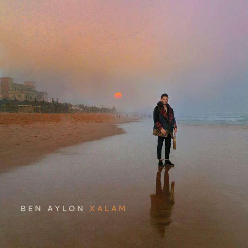 Man with guitar on beach at sunset, album cover for Aylon Ben’s Xalam.