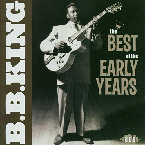 B.B. King in a suit playing an electric guitar on a music album cover.