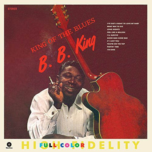 B.B. King smiling with a cigarette next to a large red guitar on album cover.