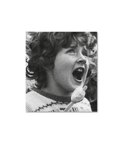 Black and white portrait of a young person with curly hair.