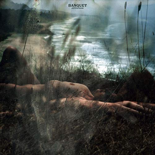"CD cover art: nude figure lying in grass by a body of water."