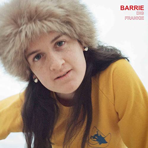 Woman in a fur hat and yellow shirt, album cover.