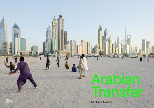 People on a beach with a modern city skyline in the background.