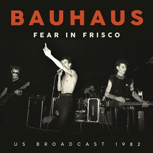 Bauhaus band members performing live in black and white, 1982.