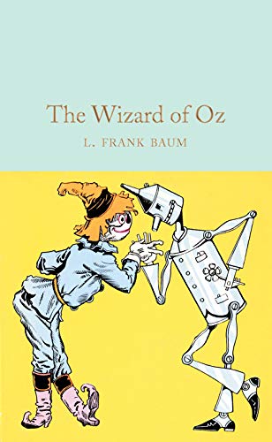 Cover of "The Wizard of Oz" showing Dorothy oiling the Tin Woodman.