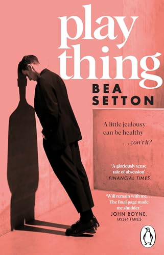 Book cover: a man in black suit with a long shadow, titled "plaything".