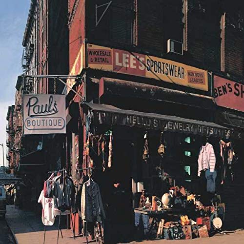 Street view of a storefront with a Paul's Boutique sign and Lee's Sportswear awning.