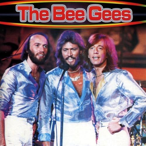 The Bee Gees, three men in patterned shirts, smiling at the camera.