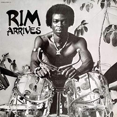 Black and white vinyl album cover featuring a shirtless man playing drums amidst foliage.