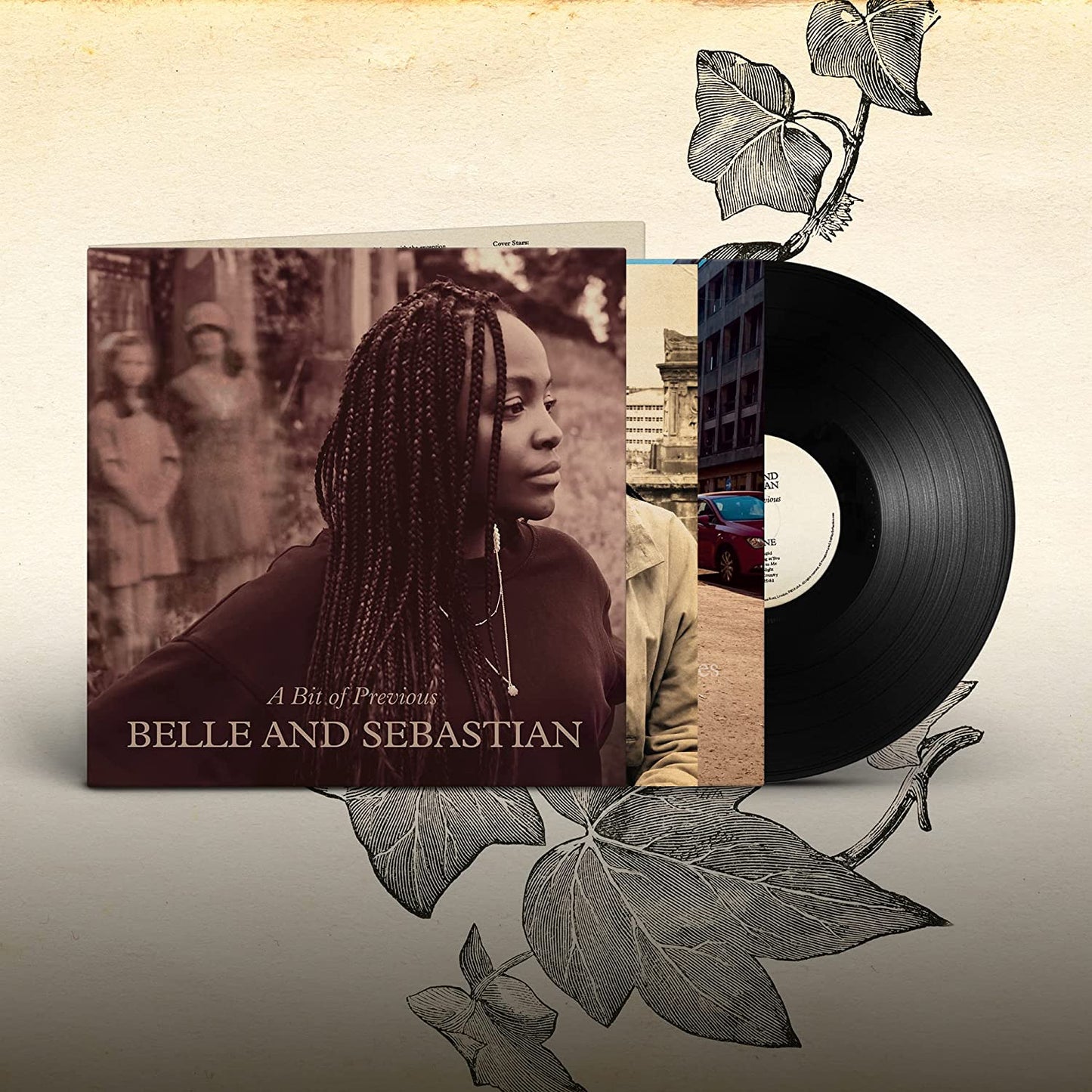 Black vinyl record and album cover with woman and two girls in background.