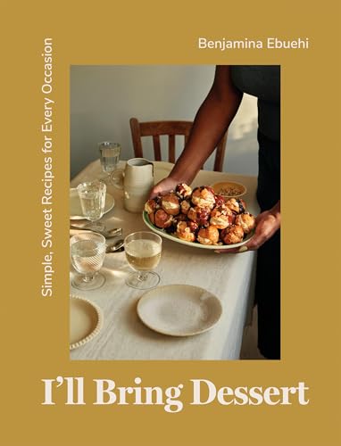 Cookbook cover with a person holding a plate of cinnamon rolls.