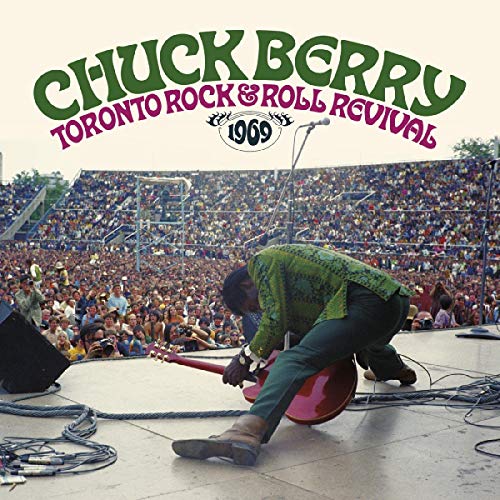 Chuck Berry performing onstage at a crowded 1969 concert.