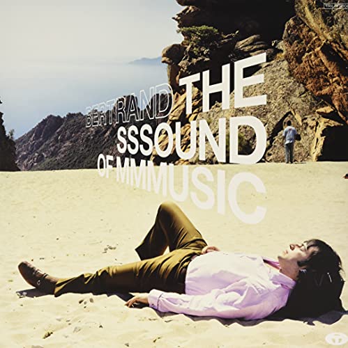 Album cover: man lying on beach with mountainous landscape backdrop.