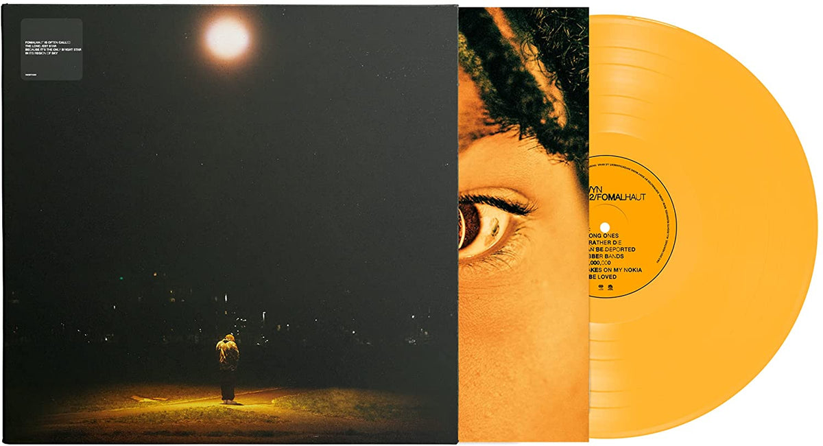 "Album cover featuring a person standing alone under a bright moonlit sky."