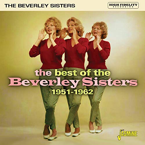 The Beverley Sisters in red sweaters and checkered pants posing against a yellow background.