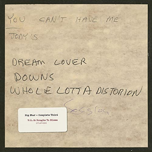 Vinyl record cover with handwritten text and a sticker label.