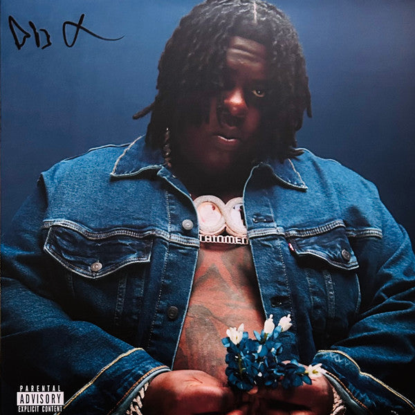 Album cover featuring a man in a denim jacket holding blue flowers.