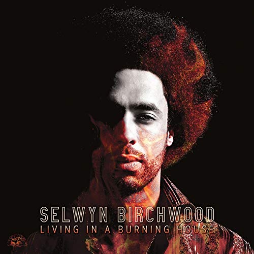 Orange vinyl record with album cover featuring a man's face against a black background.