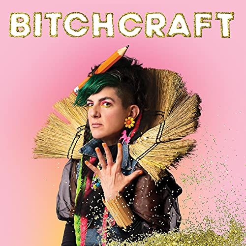 Person with green-streaked hair and broom-bristle collar against a pink background with glitter.
