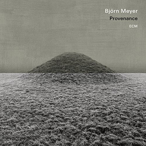 CD cover for Björn Meyer’s “Provenance” featuring a grassy mound landscape.