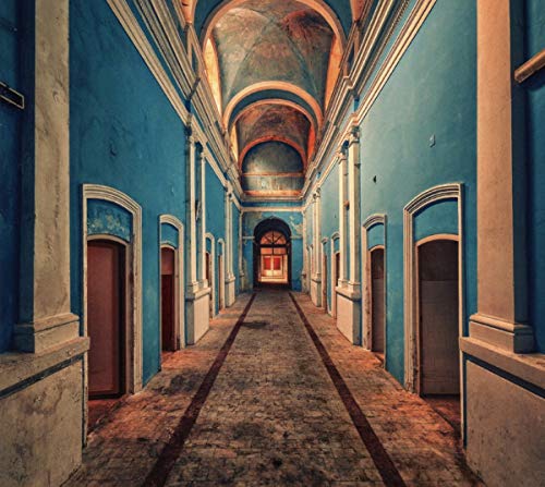 Long blue hallway with arched doorways and a distant, open doorway.
