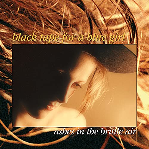 Album cover: woman with shadowed face and golden, textured background.