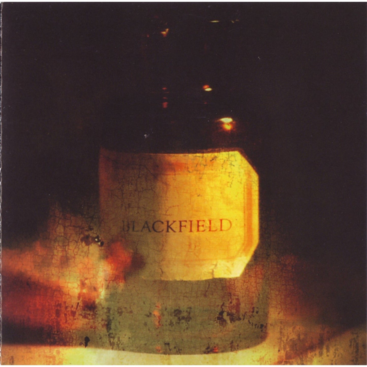 Blackfield album cover: textured gold block on dark, smoky background.