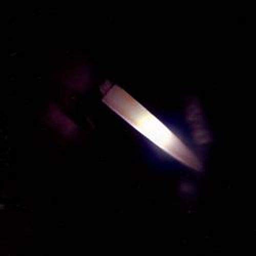 CD case with a glowing, angled blade shape against a dark background.