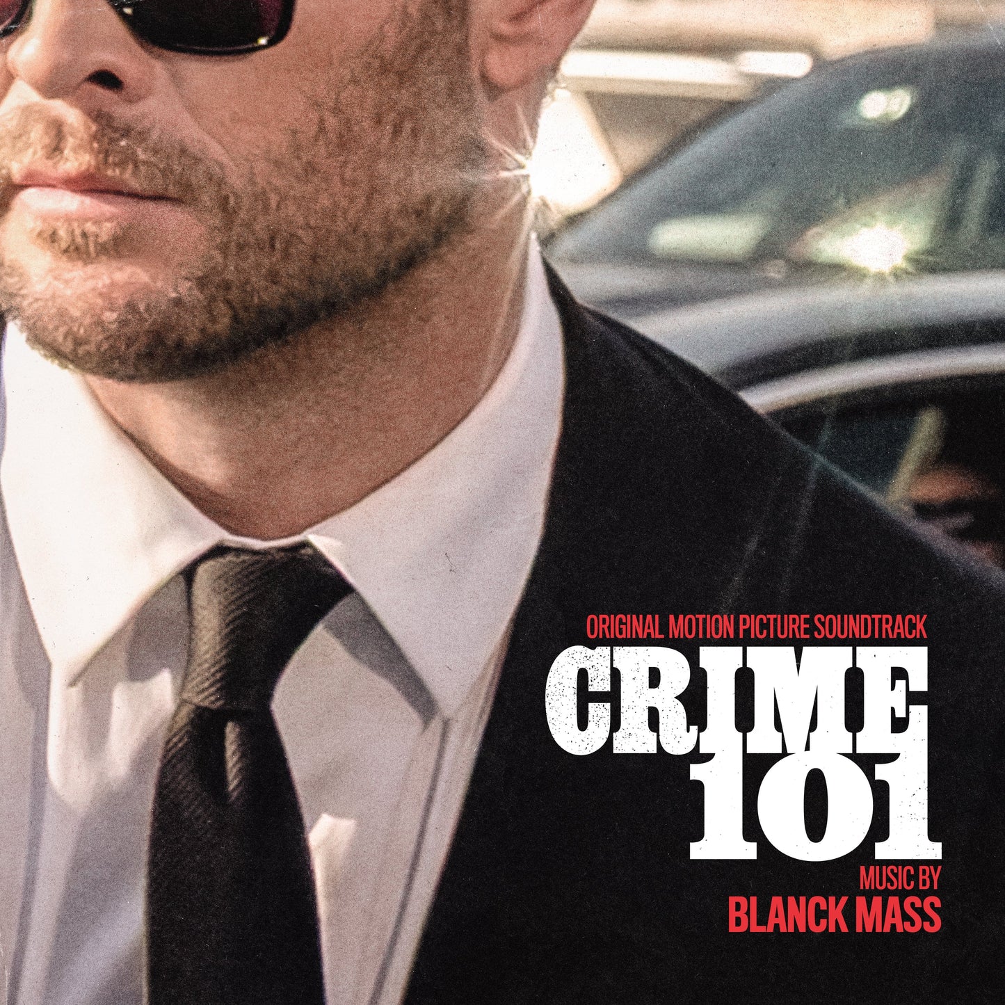 AlbumLCLose-up of a man in a suit and sunglasses for Crime 101 soundtrack.