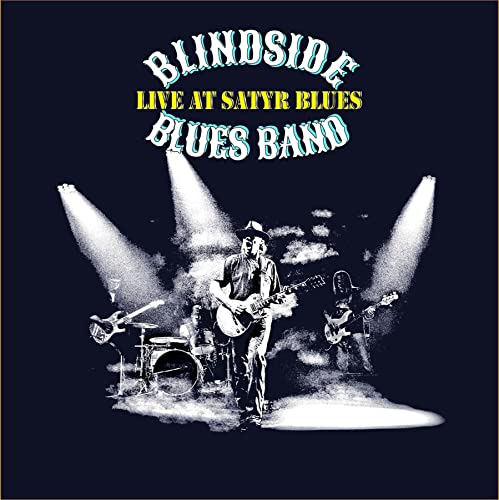 CD cover: Blues band performing onstage with spotlight and instruments.