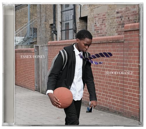 CD case with a young man holding a basketball, brick background.