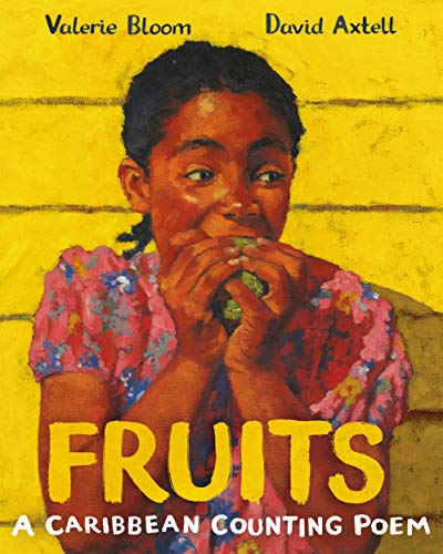 A young girl in a floral dress eats a green fruit against yellow background.