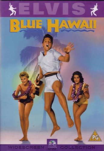 Elvis Presley jumping next to two women wearing leis on a bright blue background.