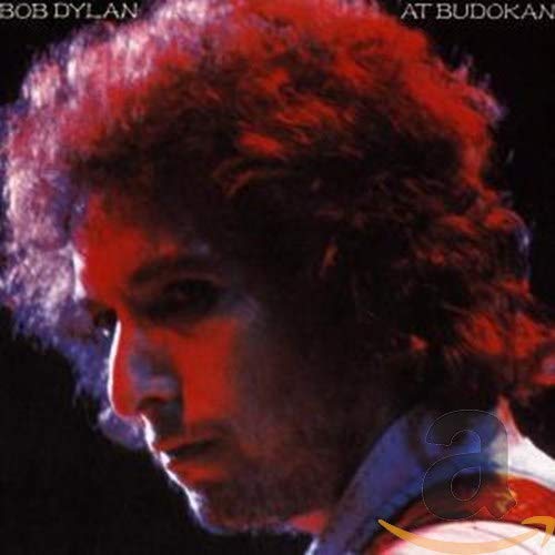 Bob Dylan album cover, "At Budokan," featuring a portrait in red tones.