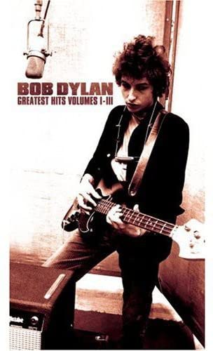Sepia-toned image of Bob Dylan playing guitar with a microphone in background.