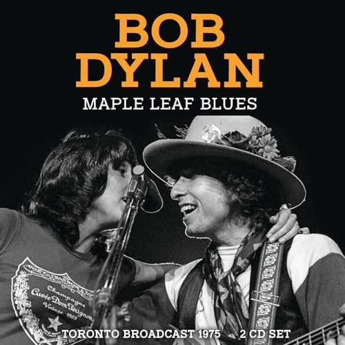 Bob Dylan wearing a floral hat singing into a microphone with another performer.