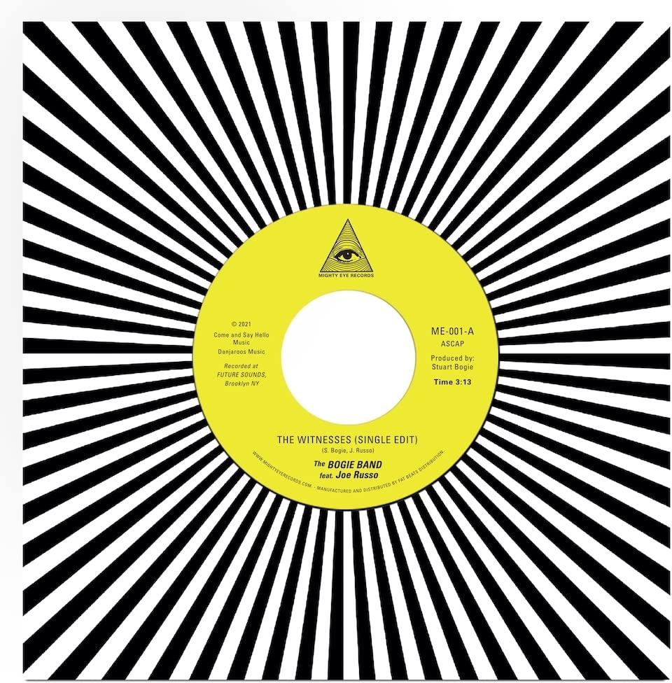 Yellow vinyl record with a black and white radial burst pattern.