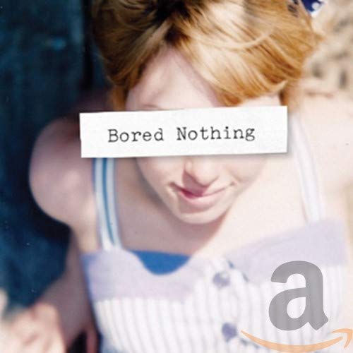 CD cover with a woman’s face partially obscured by a white label.