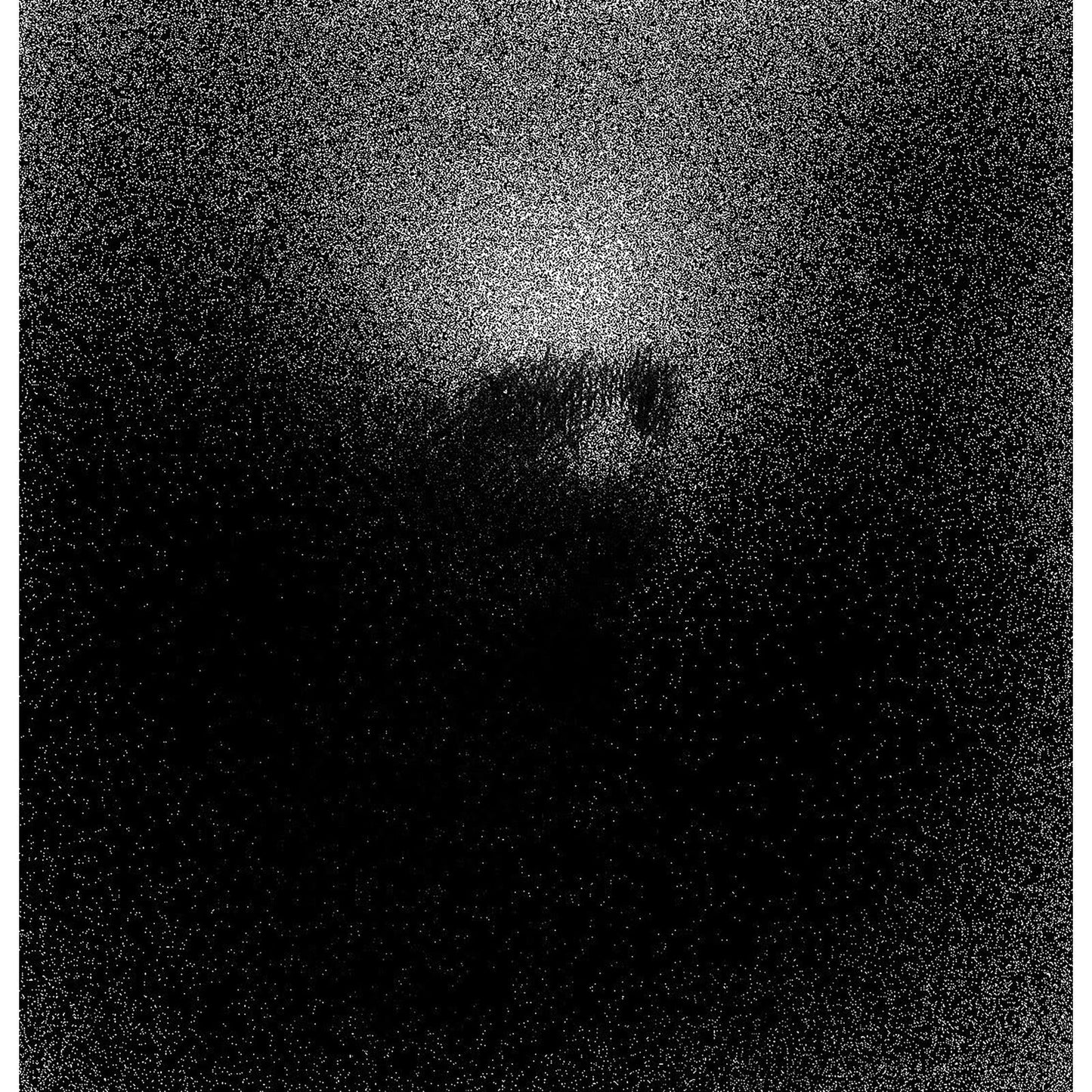 A grainy, high-contrast black and white image with a bright light centered above.