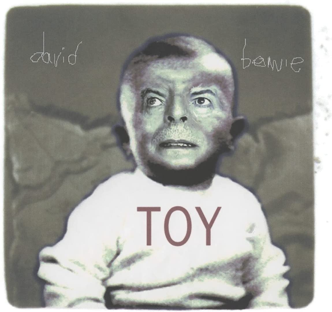 Album cover featuring a baby in a white shirt with "TOY" printed on it.