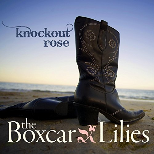 CD cover with cowboy boots on a beach, blue sky backdrop.
