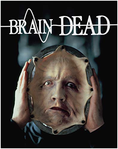 A person holds a circular frame containing a stretched human face against a black background.