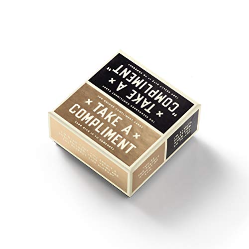 Small, boxed set of black and gold cards with “Take a Compliment” text.