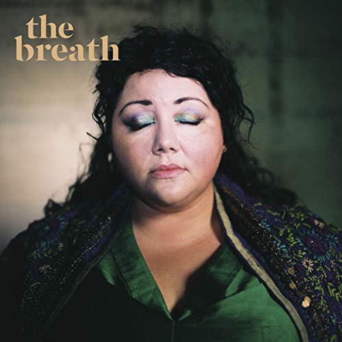 CD cover featuring a woman with dark curly hair and teal eyeshadow.