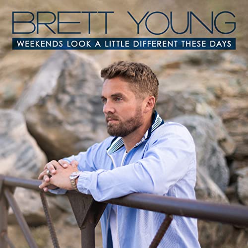 Brett Young leaning on a railing against a rocky background, album cover art.