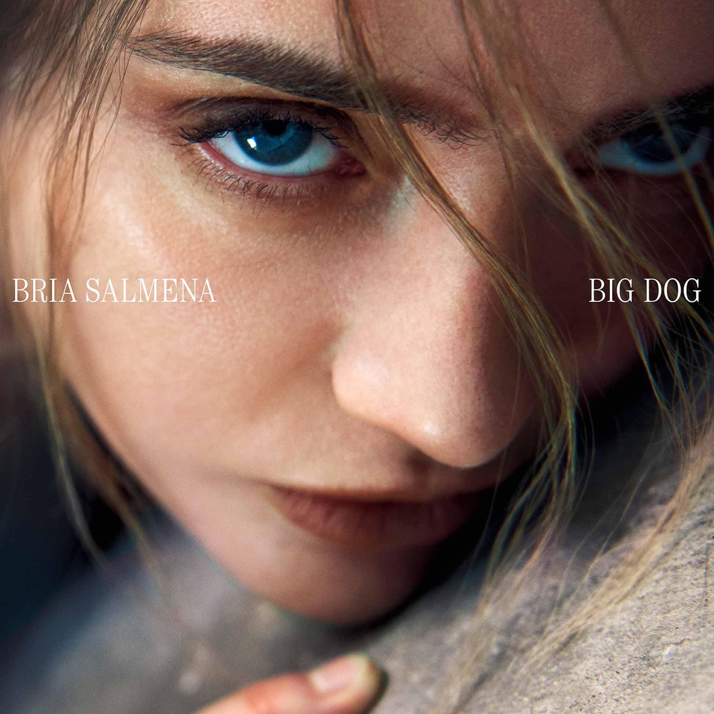 Close-up of a woman’s face and a dog’s fur, album cover art.